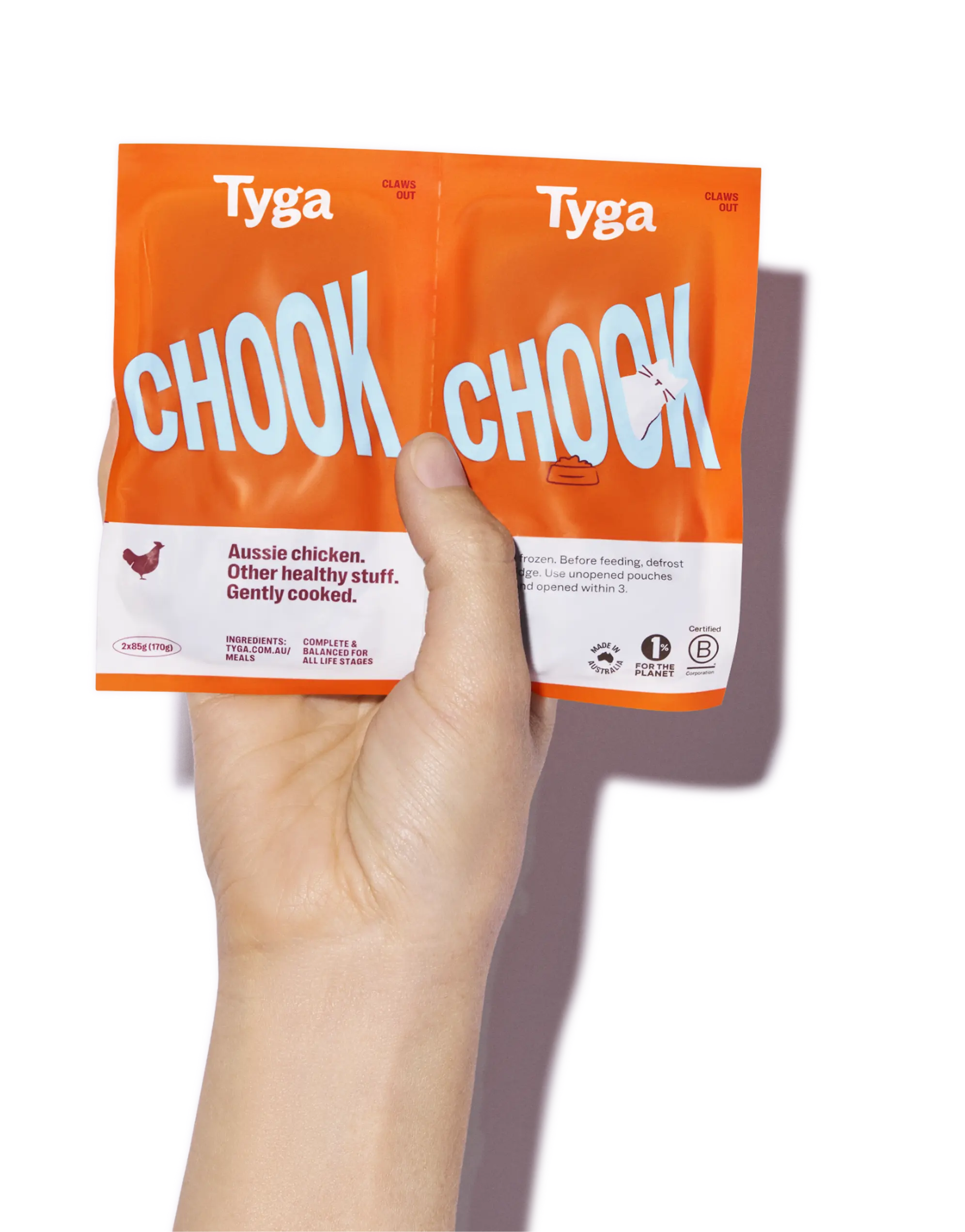 Hands holding Tyga food pouches